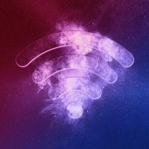Illustration représentant un symbole de connexion énergétique, semblable à un signal Wi-Fi, formé par des particules lumineuses violettes et roses dans un fond étoilé. Une ambiance cosmique et mystique émane de cette image, évoquant le magnétisme ou les énergies subtiles.